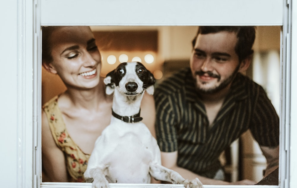 A couple celebrating at home with their dog